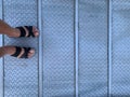 Woman wearing sandals on a metal ramp