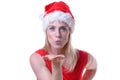 Woman wearing Santa hat and blowing a kiss Royalty Free Stock Photo