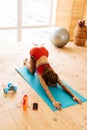 Woman wearing sport shorts and top stretching after tabata