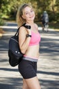 woman wearing sportswear and carrying bag over shoulder
