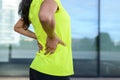 Woman wearing sportswear holding painful back Royalty Free Stock Photo