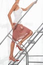 Woman wearing stilleto heel on metal staircase