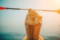 A woman wearing a straw hat is paddling a canoe on a sunny day. Scene is relaxed and carefree, as the woman enjoys her Royalty Free Stock Photo