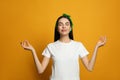 Young woman wearing stylish bandana on orange background Royalty Free Stock Photo