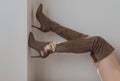 Woman wearing Stylish Brown suede female high boot with high heel. Royalty Free Stock Photo