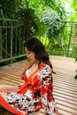 Beautiful young woman wearing summer clothes on tropical resort