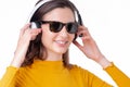 Woman wearing sunglasses and listening to headphones