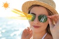 Woman wearing sunglasses near sea. UVA and UVB rays reflected by lenses, illustration