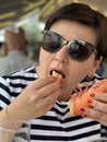 Woman Eating Huge Langoustine In Food Court Of A Seafood Market In Trouville, France