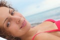 Woman wearing swimsuit is laying near water Royalty Free Stock Photo