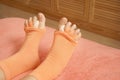 Woman wearing yoga toe separator socks in bed