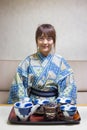 Woman wearing traditional japanese yukata or kimono make a tea