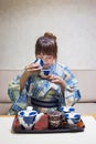 Woman wearing traditional japanese yukata or kimono make a tea