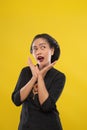 Woman wearing traditional Javanese dress and bun surprised