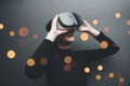 Woman wearing virtual reality goggles in modern coworking studio. Smartphone using with VR headset. Horizontal, blurred