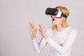 Woman wearing virtual reality goggles. Person with virtual reality helmet isolated on grey background. Woman with Royalty Free Stock Photo