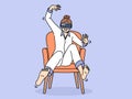 Woman wearing VR headset sits in chair and waves arms and legs, being immersed in virtual reality