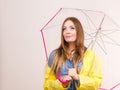 Woman wearing waterproof coat holding umbrella