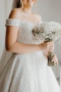 a woman wearing a wedding dress and holding flowers in her hand Royalty Free Stock Photo