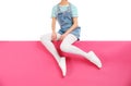 Woman wearing white tights and stylish shoes sitting on background, closeup Royalty Free Stock Photo