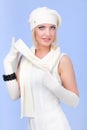 Woman wearing a winter cap and gloves on a blue Royalty Free Stock Photo
