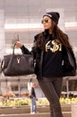 Woman wearing Yves Saint Laurent Black T-Shirt & H