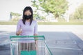 A woman wears a black mask and alcohol spray