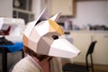 A woman wears a fox mask