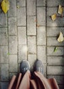 looking down at shoes on the pavement in autumn Royalty Free Stock Photo