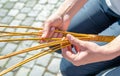 A woman weaves his Easter whip from a rod