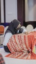 A woman is weaving cloth, or so-called traditional tapis cloth