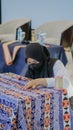 A woman is weaving cloth, or so-called traditional tapis cloth