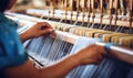 A Woman Skillfully Weaving Colorful Fabric on a Traditional Loom