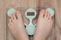 Woman is weighed on scales, Barefoot woman standing on digital scales. Concept of dieting, loosing weight and healthy lifestyle