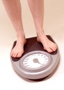Woman on weighing machine Royalty Free Stock Photo