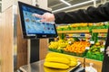 A woman weighs bananas on a scale in a supermarket. April 13, 2023 Balti, Moldova. Illustrative editorial.