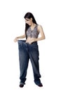 Woman after weight-loss trying her old jeans Royalty Free Stock Photo