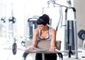 Woman with weight training equipment on sport gym