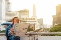 Woman westerner looking at map during city tour in the morning, Royalty Free Stock Photo