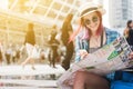 Woman westerner looking at map and smartphone during city tour i Royalty Free Stock Photo