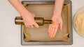 Woman wetting hands with olive oil to prevent sticking while working with pizza dough