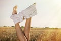 Woman in wheat crown undressing shorts. Summer sky above field. Royalty Free Stock Photo