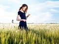Woman at wheat field on sunny day Royalty Free Stock Photo
