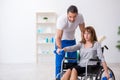 Woman in wheel-chair doing sport exercises with personal coach Royalty Free Stock Photo