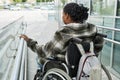 Woman in Wheelchair on Accessibility Ramp in City