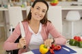 woman in wheelchair cutting peppers in kitchen Royalty Free Stock Photo