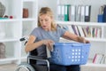 Woman in wheelchair doing laundry