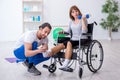 Woman in wheel-chair doing sport exercises with personal coach Royalty Free Stock Photo