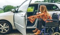 Woman in wheelchair getting on car Royalty Free Stock Photo