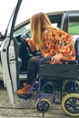 Woman in wheelchair getting on car Royalty Free Stock Photo